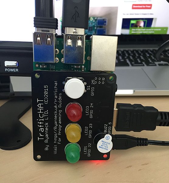 Figure 3: The TrafficHAT module for the Raspberry Pi, which includes 3 LED lights, a buzzer, and push button, all of which are programmable via GPIO.